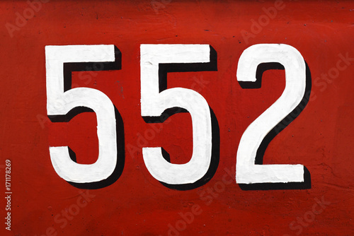 White 3d number 552 on red