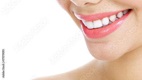 Closeup shot of woman's smile with white healthy teeth, isolated on white background