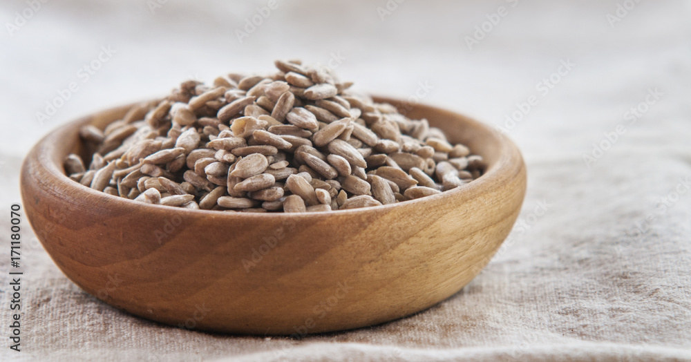 bowl of sunflower seeds isolated on white background bowl of sunflower seeds isolated on white background