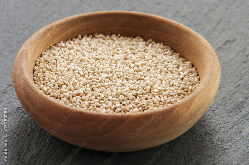 Sesam seeds in a little bowl wooden Natural light. Selective focus. Sesam seeds in a little bowl wooden Natural light. Selective focus.