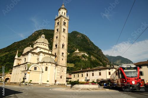Bernina Express Arrive in the Square of Tirano in Italy, Basilica Madonna di Tirano.  photo