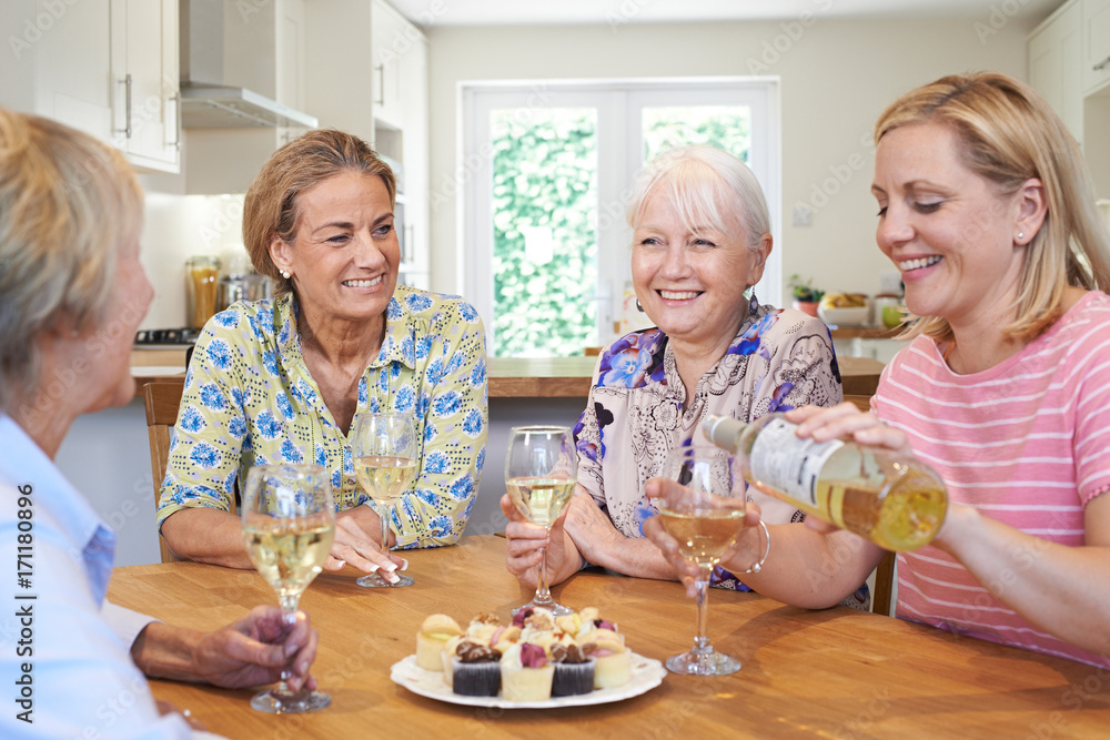 Group Of Different Aged Female Friends Relaxing At Home And Drinking Wine Group Of Different Aged Female Friends Relaxing At Home And Drinking Wine