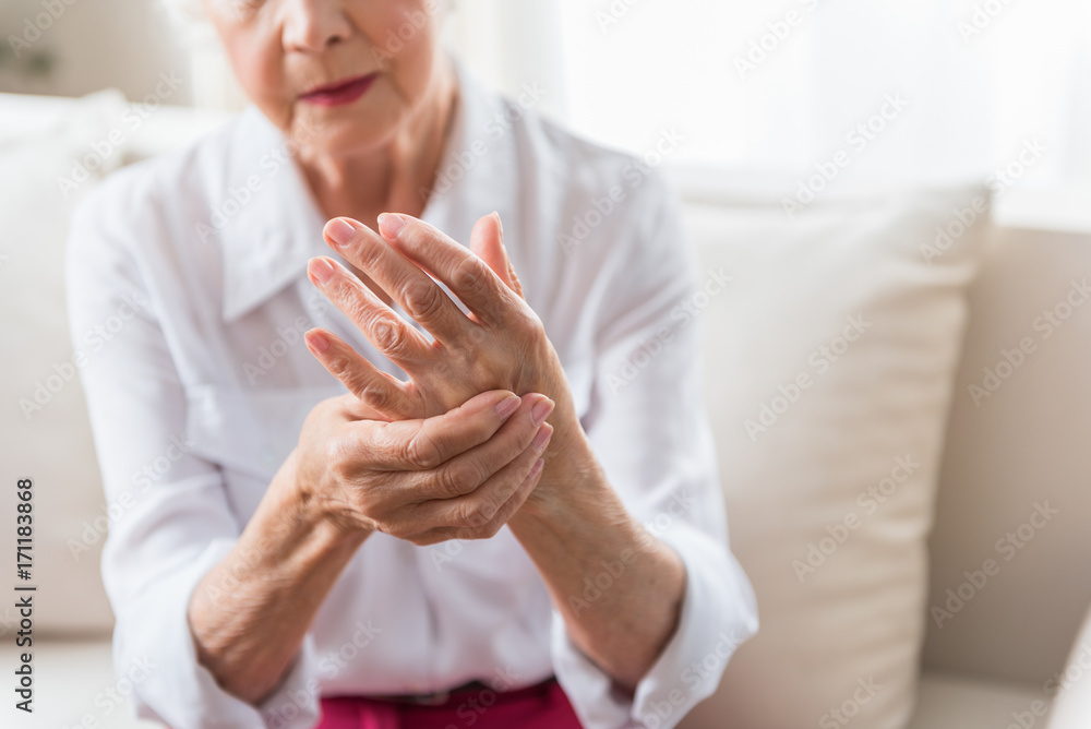 Elderly female is expressing pain - obrazy, fototapety, plakaty 