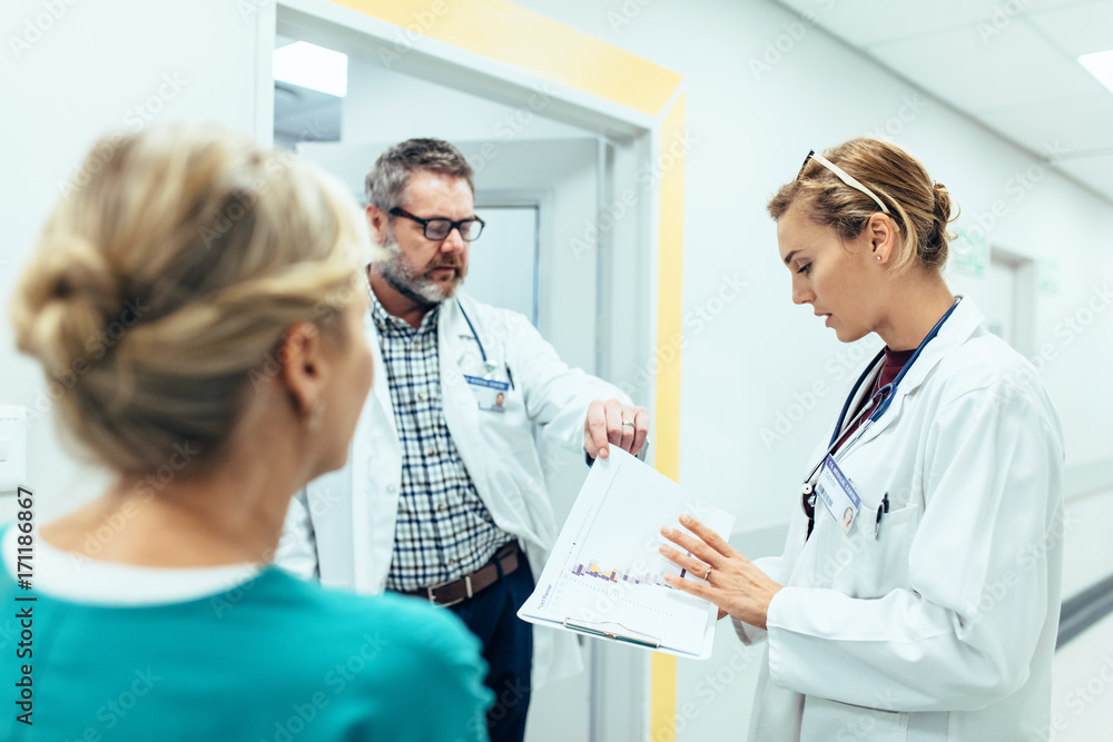 Medical staff having discussion in hospital corridor Medical staff having discussion in hospital corridor