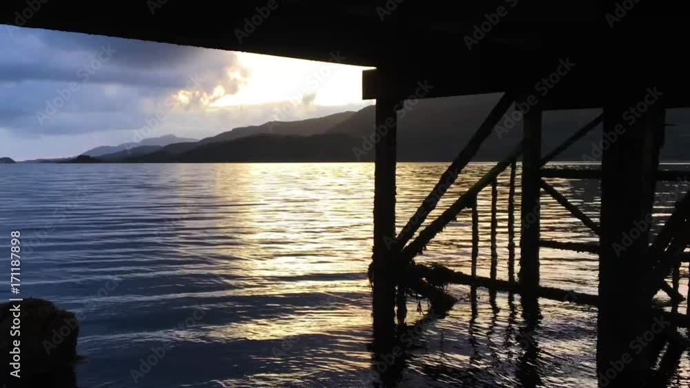 Waters flow and ripple underneath the wooden dock of Loch Sunart 4K Waters flow and ripple underneath the wooden dock of Loch Sunart 4K