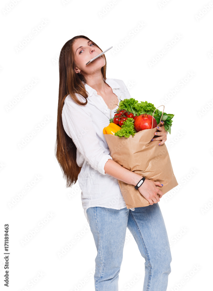 Young woman holding shopping bag full of vegetables isolated on white background. Young woman holding shopping bag full of vegetables isolated on white background.