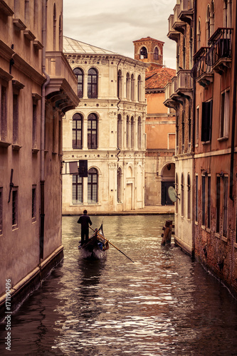 Gondola floats along the narrow canal in Venice