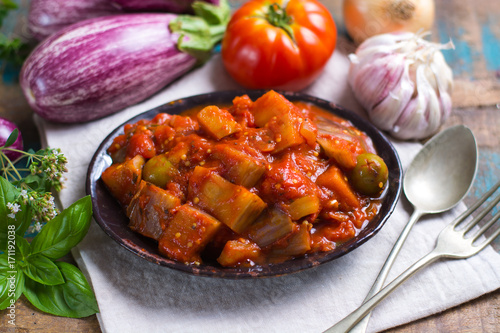 Best italian food - sicilian caponata with eggplants, tomatoes, onion, garlic and herbs photo