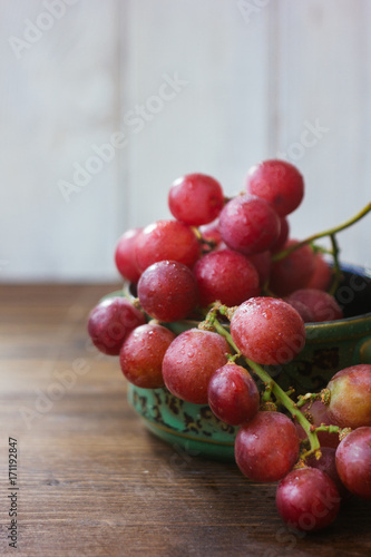ceramic bowl filled by bunch of fresh grapes
