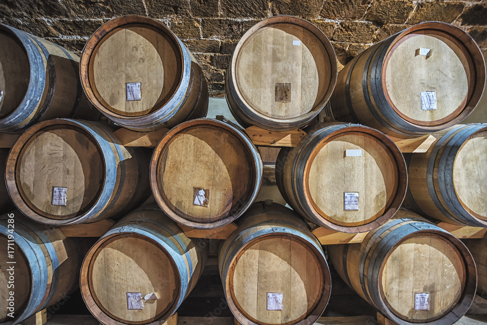 Picture of wooden wine barrels in the wine cellar Picture of wooden wine barrels in the wine cellar