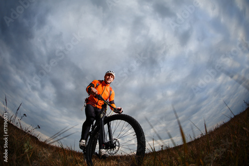 Bike adventure travel photo. Bike tourists ride on the countryside downhill.