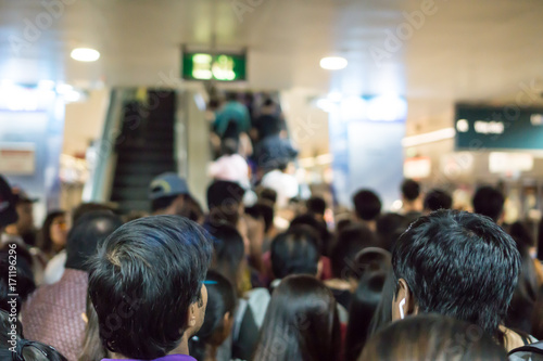 Crowded Asian people queue for escalator to exit from public subway during rush hour © vanila91