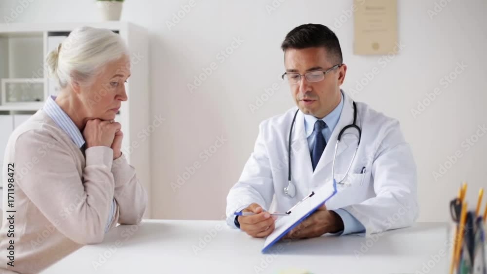 senior woman and doctor with cardiogram at clinic senior woman and doctor with cardiogram at clinic