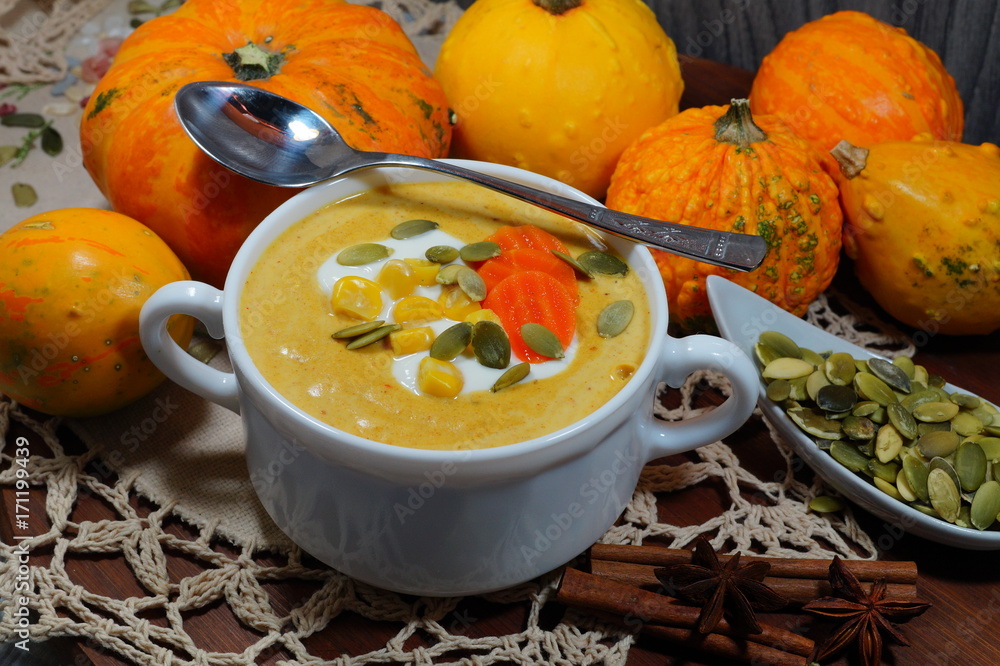Spicy pumpkin soup in a white bowl, selective focus Spicy pumpkin soup in a white bowl, selective focus