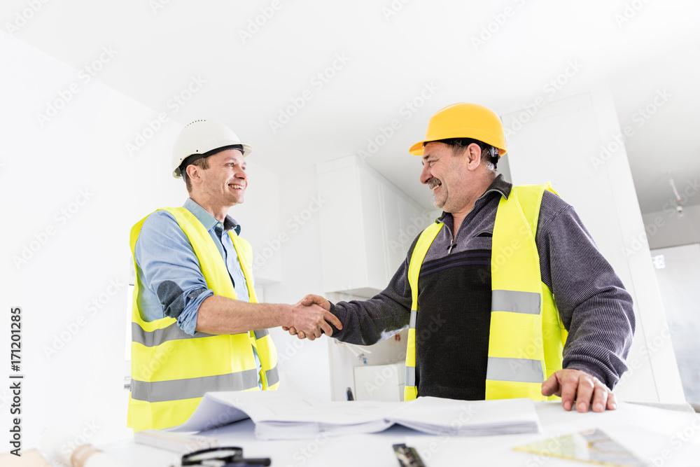 Architect and construction engineer handshake. Architect and construction engineer handshake.