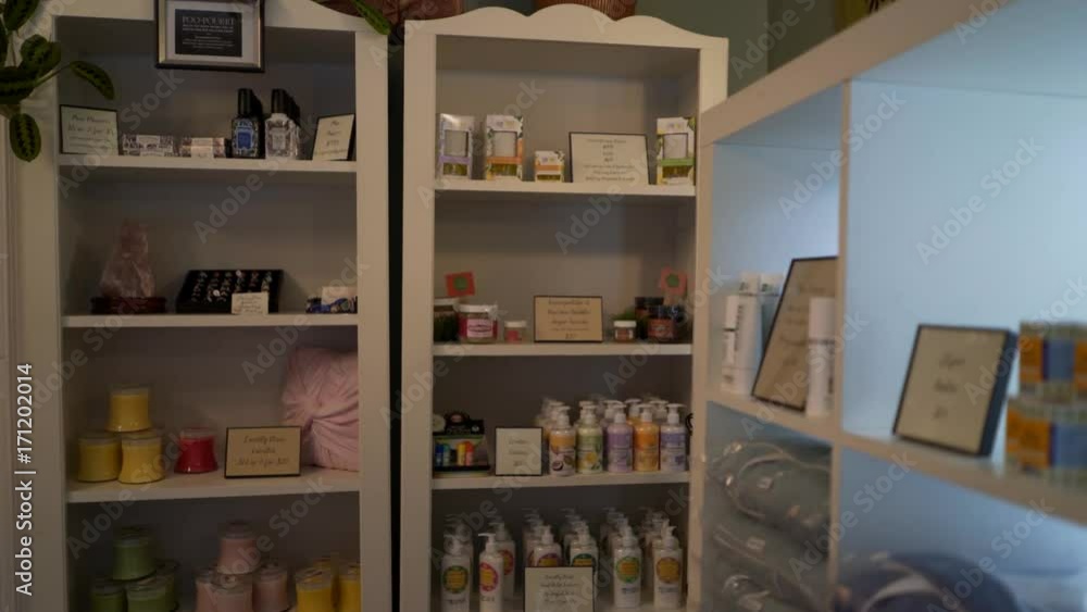 Beautiful woman peruses spa merchandise like soaps, oils and robes. Steadicam shot. Beautiful woman peruses spa merchandise like soaps, oils and robes. Steadicam shot.