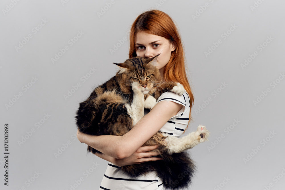 woman holding a cat, portrait, gray background