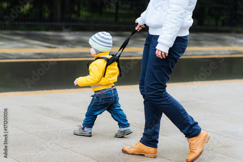  Mom insures her child during a walk photo