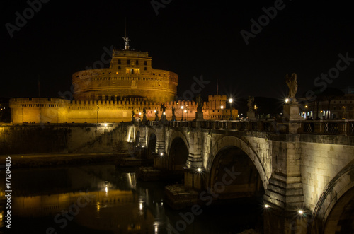 Castel Sant Angelo in Italy Rome at night over Tiber River with reflection