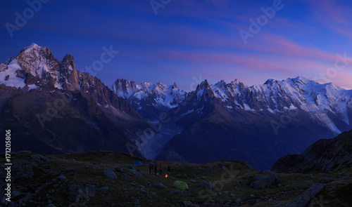 Campfire at a campsite in the mountains near Chamonix, France, during a colorful sunset.