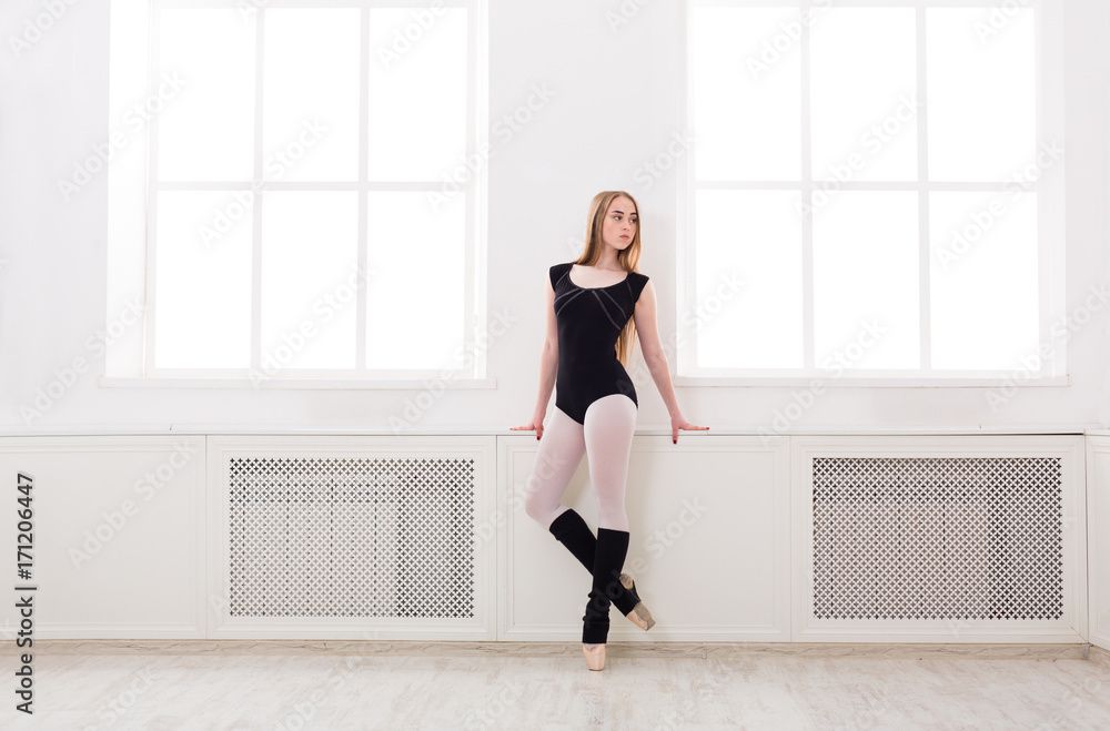 Beautiful ballerina stands near window Beautiful ballerina stands near window