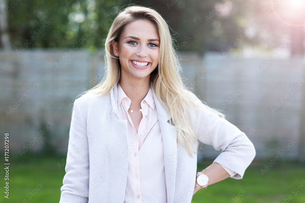 Fototapeta premium Outdoor close up portrait of young beautiful happy smiling woman
