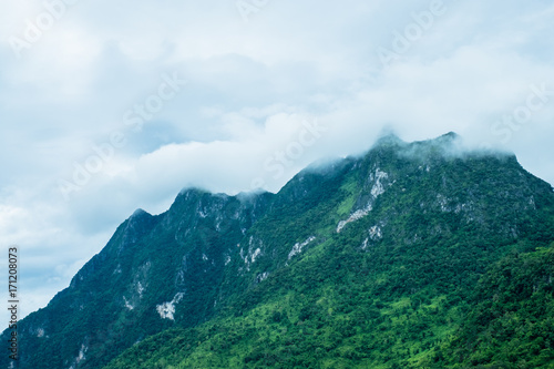 The fog over green mountain at sunset in north of Thailand