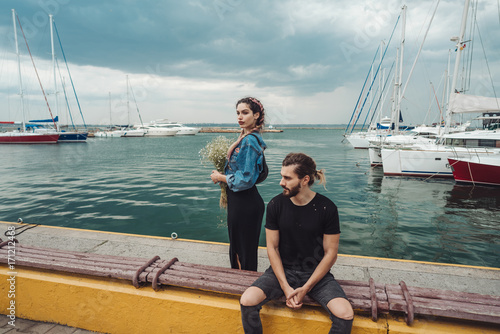Guy and girl on pier © teksomolika