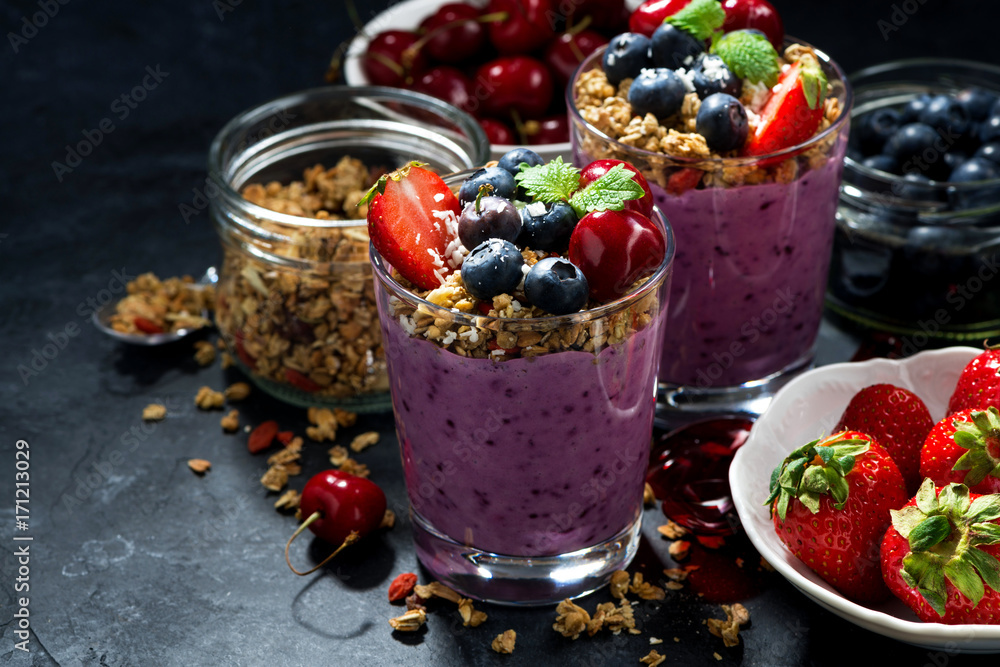 healthy blueberry with granola and berries on a dark background healthy blueberry with granola and berries on a dark background