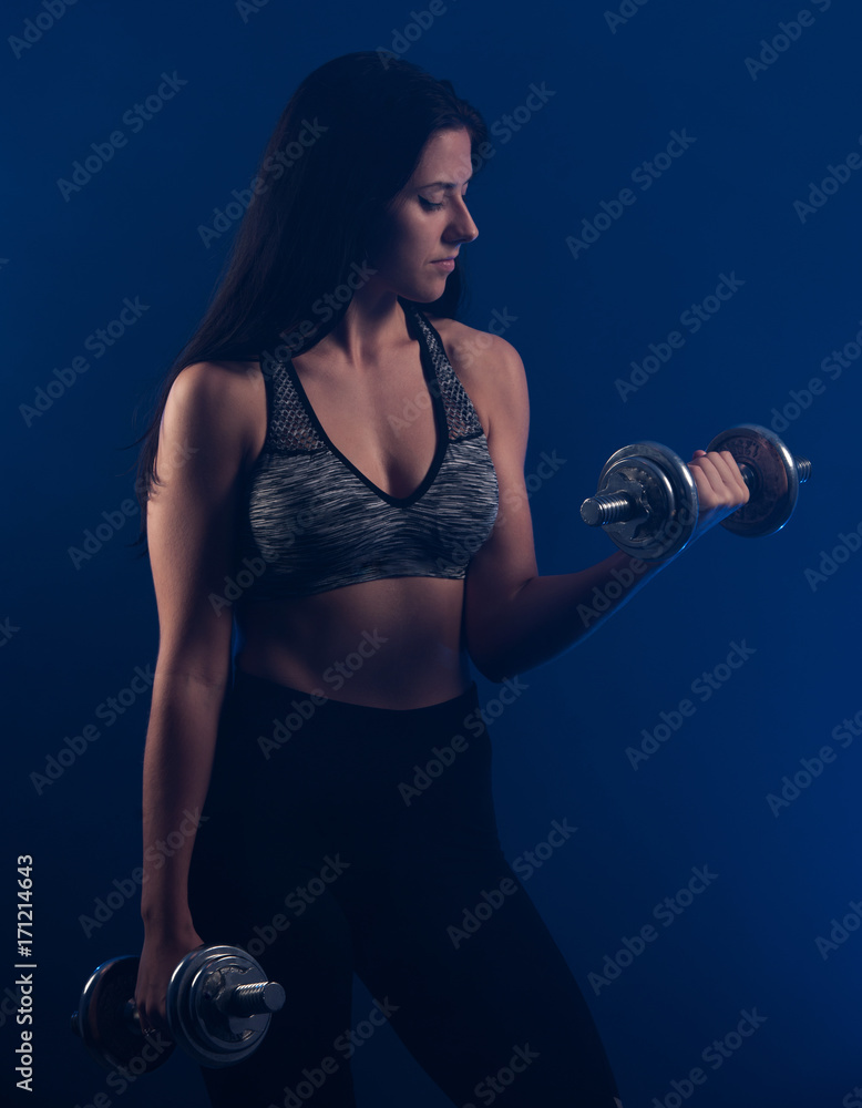 Active young woman workout with dumbbells Active young woman workout with dumbbells
