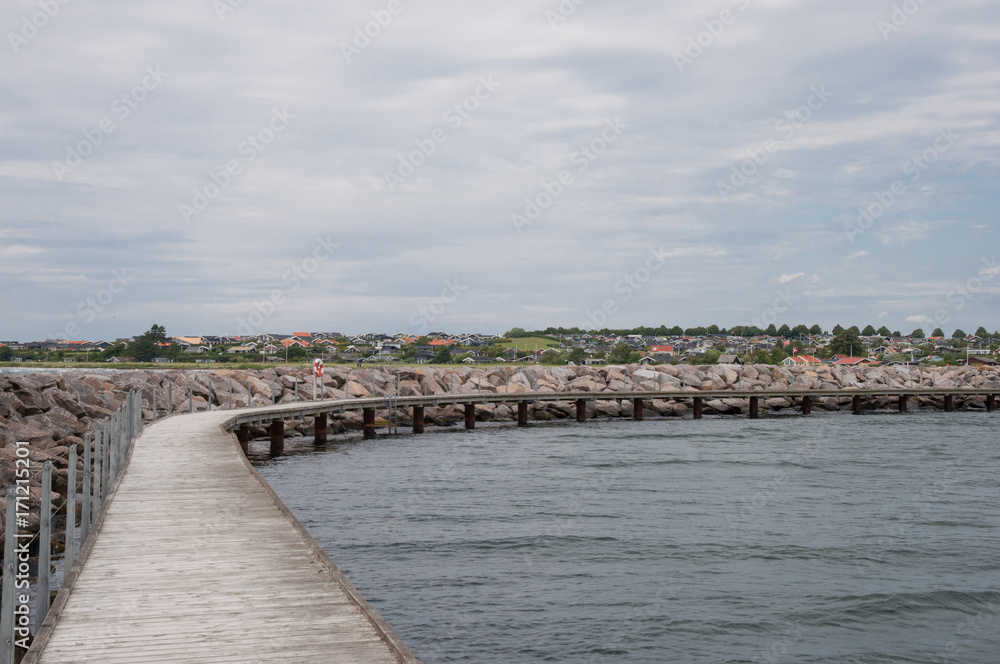 Walking platform along a breakwAter in Danish vacation town of Karrebaeksminde