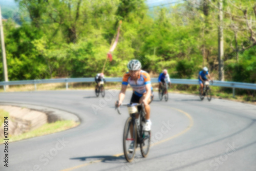 Blur active road bicycle racer on outdoor training