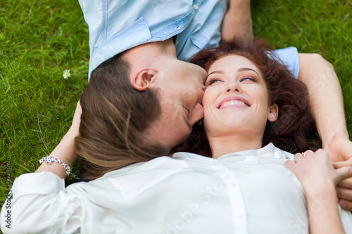 Happy couple lying on the grass