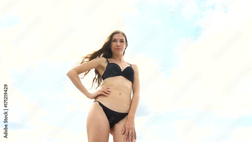 Charming girl in lingerie posing on the sky background Charming girl in lingerie posing on the sky background