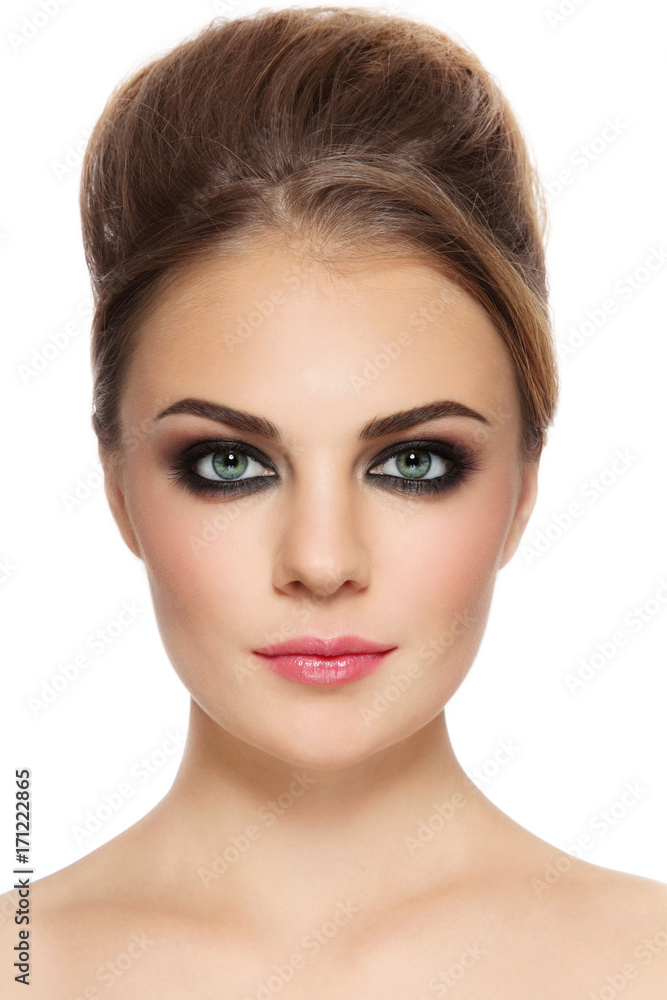 Portrait of young beautiful woman with smoky eyes and hair bun Portrait of young beautiful woman with smoky eyes and hair bun