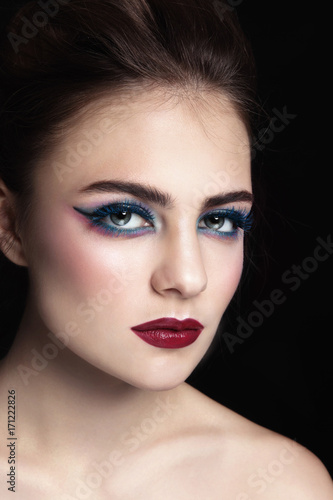 Glamorous portrait of young beautiful woman with colorful fancy make-up