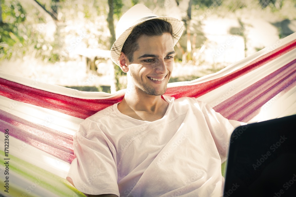 man in the hammock with laptop man in the hammock with laptop