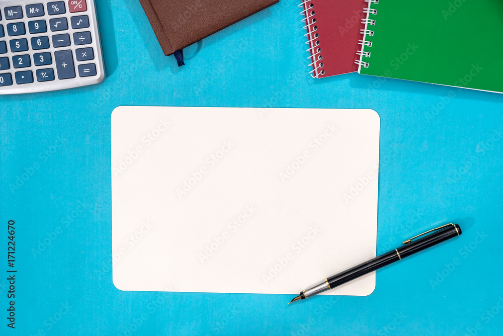 notebook, calculator and pen isolated on blue background notebook, calculator and pen isolated on blue background