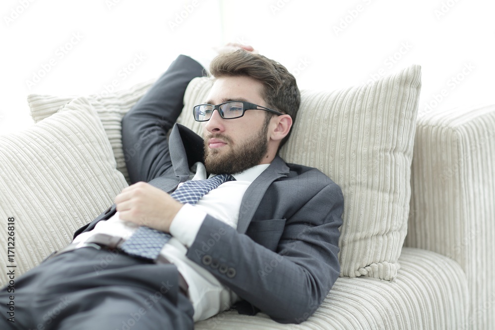 tired businesswoman relaxing on the couch. tired businesswoman relaxing on the couch.