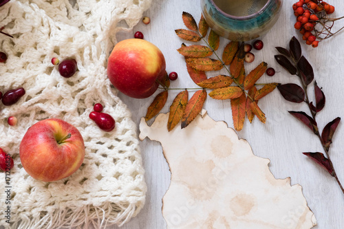 Fresh Pastry Bun, Cup of hot coffee and autumn leaves on wooden background. Wooden letters word AUTUMN. Top view, copy space photo