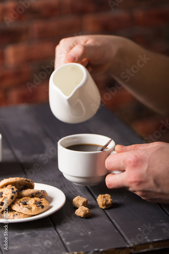 hot black coffee with cookies and beans in cafe