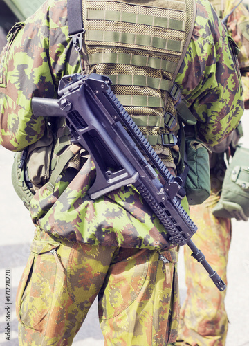 A soldier with G36 rifle  in front of M113 photo