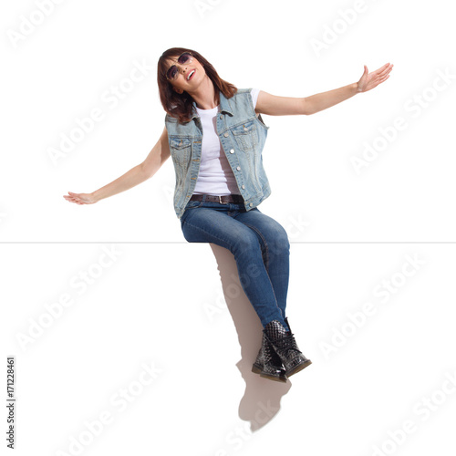Dreamer Woman Is Sitting On A Top With Arms Outstretched And Looking Up