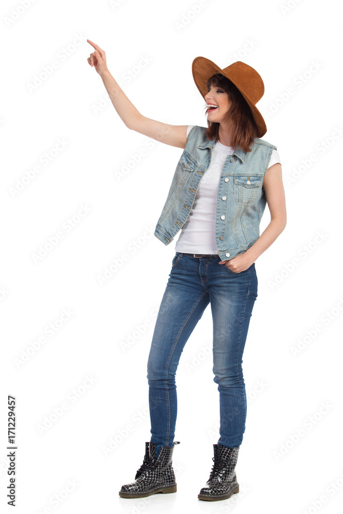 Laughing Young Woman In Brown Suede Hat Is Looking Away And Pointing Laughing Young Woman In Brown Suede Hat Is Looking Away And Pointing