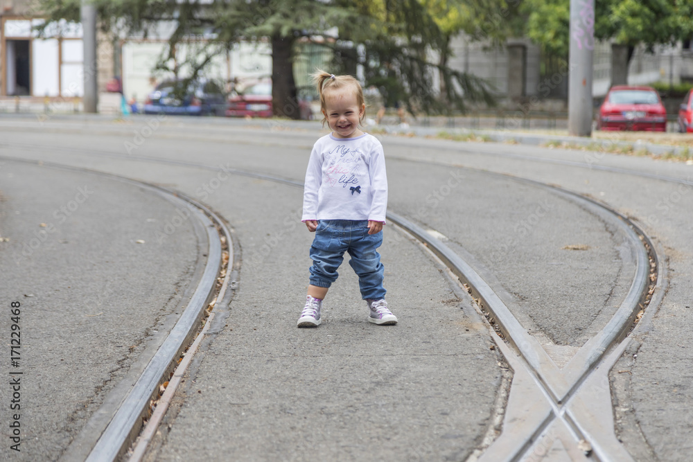 Cute little girl walking alone on the street. Cute little girl walking alone on the street.