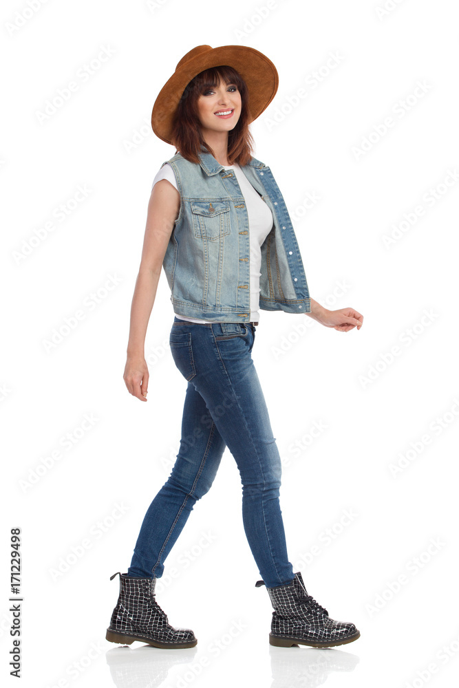 Young Woman In Brown Suede Hat Is Walking And Smiling Young Woman In Brown Suede Hat Is Walking And Smiling