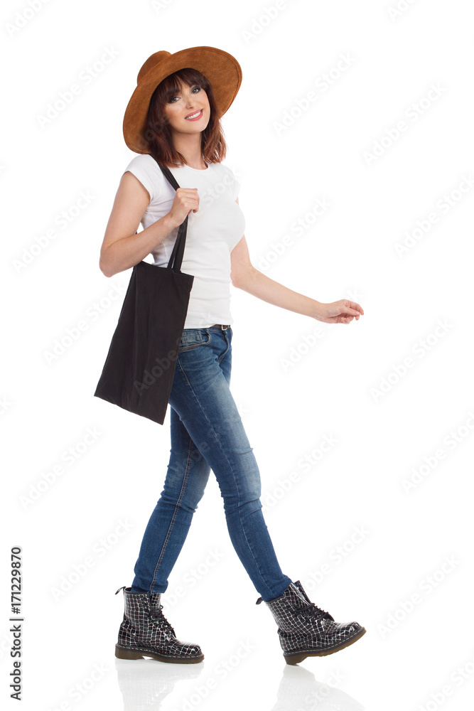 Smiling Woman Is Walking And Holding Black Shopping Bag On Her Shoulder Smiling Woman Is Walking And Holding Black Shopping Bag On Her Shoulder