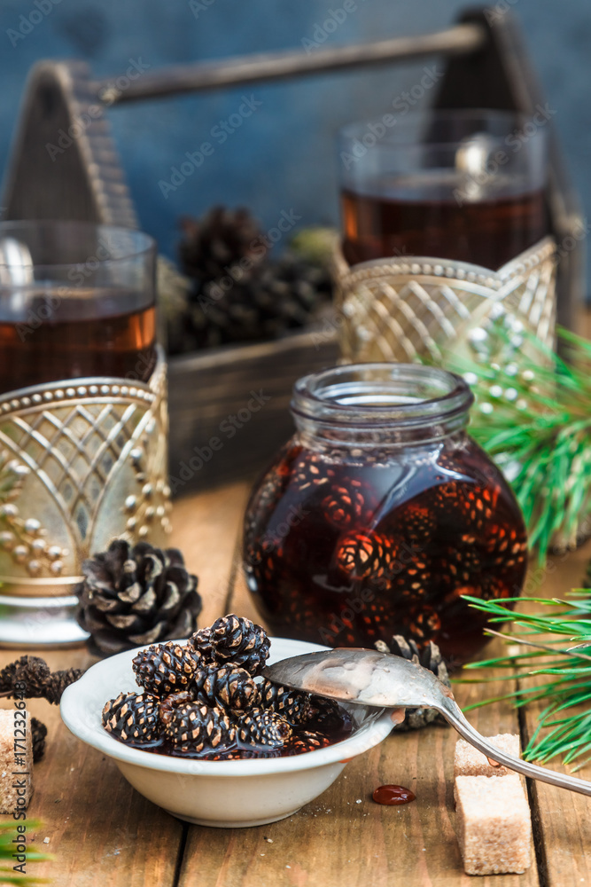 Candied young pine cones on a small plate on a wooden. Candied young pine cones on a small plate on a wooden.
