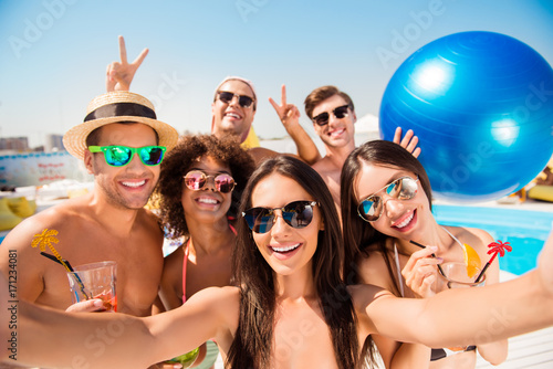 Canvas Print Selfie time! Six cheerful friends in fashionable different swim wear and sun pro