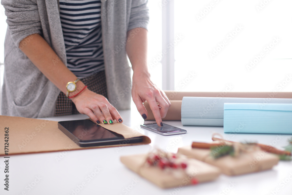 Hands of woman decorating christmas gift box Hands of woman decorating christmas gift box